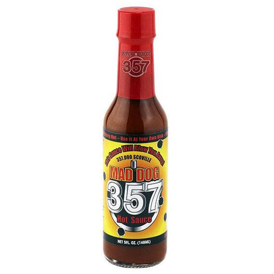 Bottle of Mad Dog 357 hot sauce with a red cap on a white background