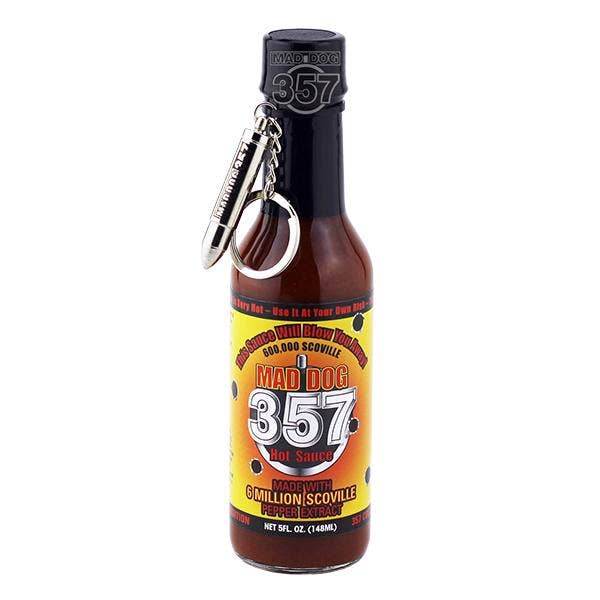 A bottle of 357 Hot Sauce by Mad Dog Schoville with a black cap and a silver metal keychain attached, shown on a plain white background.