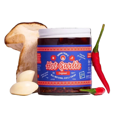 Jar of 'Hot Garlic' with a mushroom, garlic, and red chili pepper on a white background