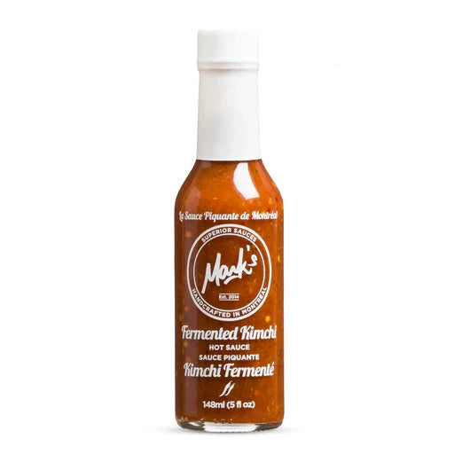 Bottle of fermented kimchi hot sauce with 'Hot Ones' branding on a white background