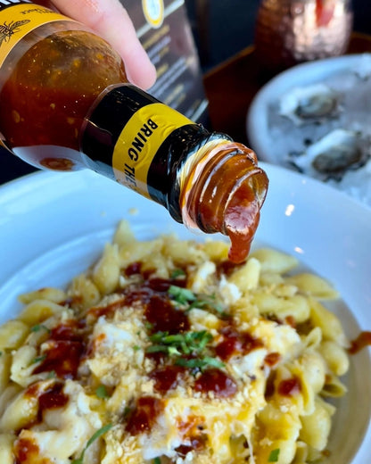 Murder Hornet Honey Bourbon Hot Sauce pouring over eggs