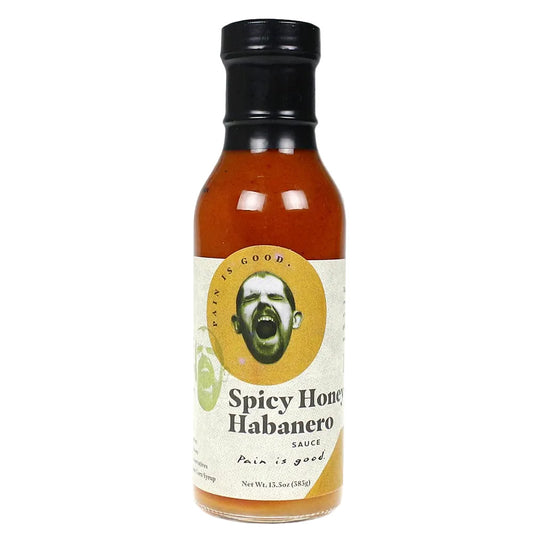 Bottle of Spicy Honey Habanero sauce with a label featuring a face and text on a white background