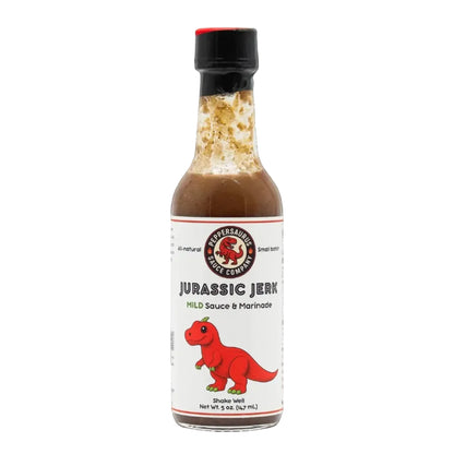 A bottle of Jurassic Jerk Mild Sauce & Marinade by Flavour Factory, featuring a white label with a red cartoon dinosaur and a black cap, set against a plain white background.