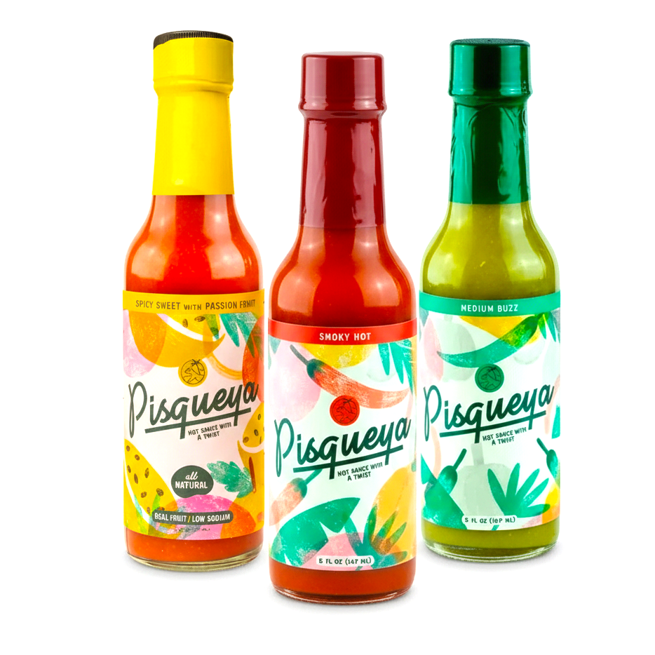 Three bottles of Pisqueya hot sauce with colorful labels on a white background