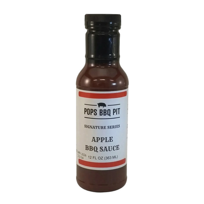 Bottle of Pops BBQ Pit Apple BBQ Sauce on a white background