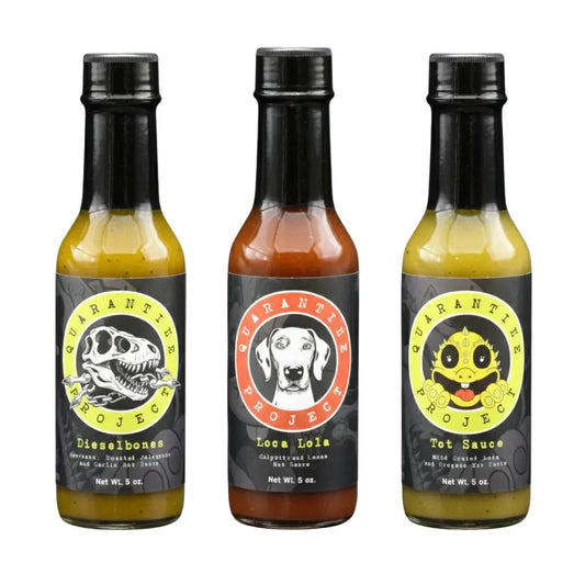 Three bottles of 'Quarantine Project' hot sauce with different labels on a white background.