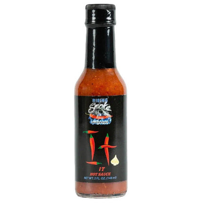 Bottle of Rising Smoke hot sauce with a black label