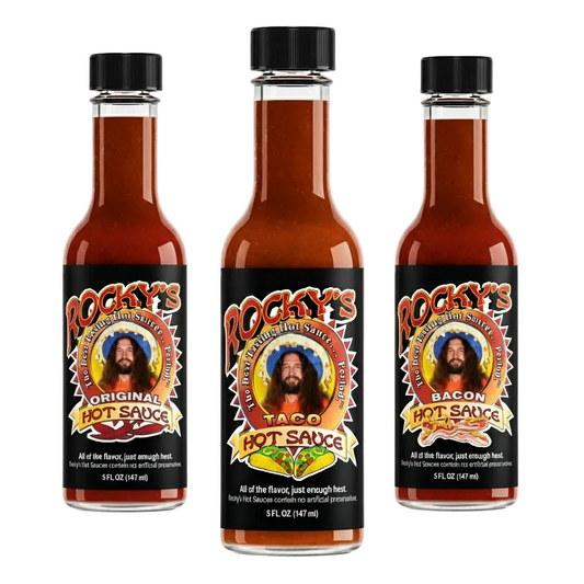 Three bottles of Rocky's Hot Sauce with different flavors on a white background