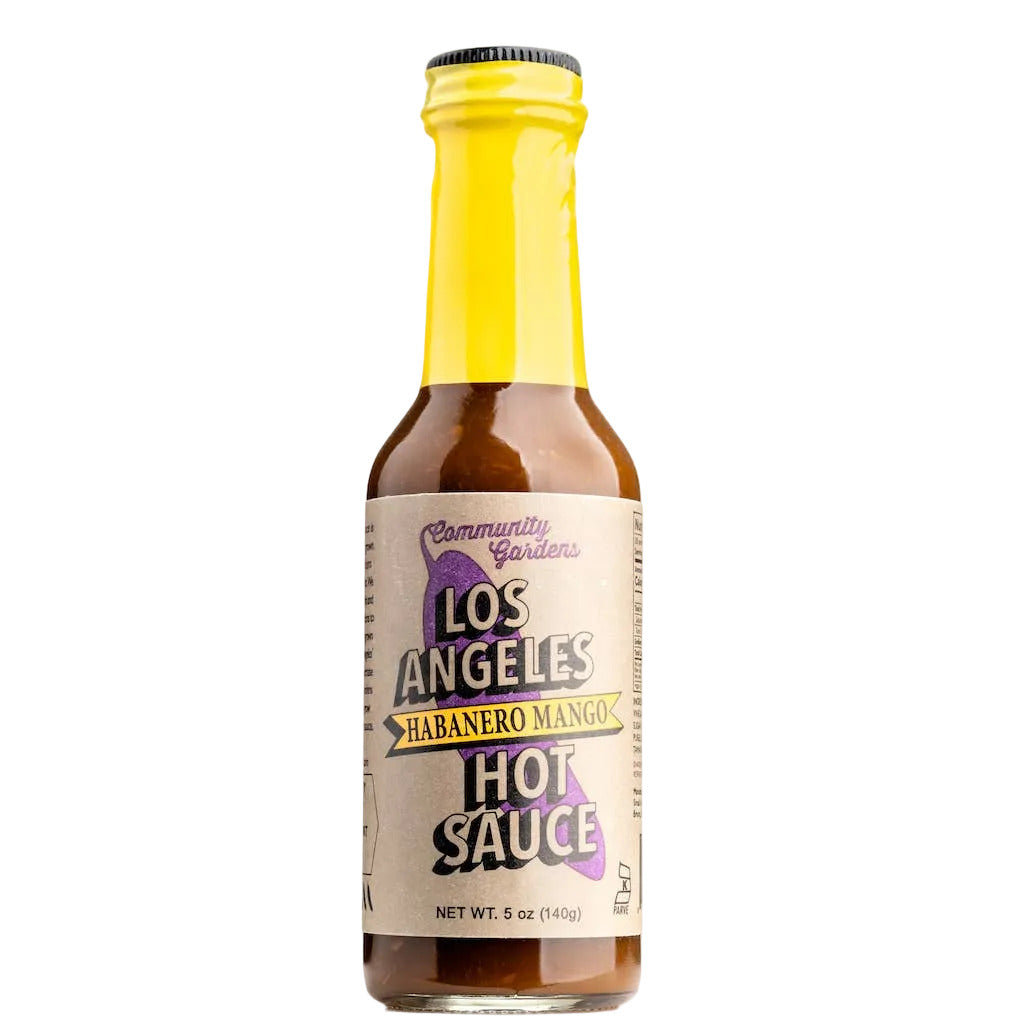 Bottle of Los Angeles Habanero Mango Hot Sauce with yellow cap on white background