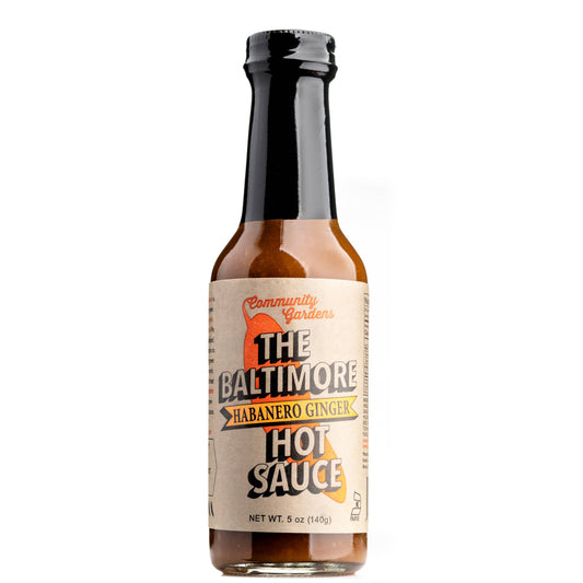 Bottle of The Baltimore Habanero Ginger Hot Sauce on a white background