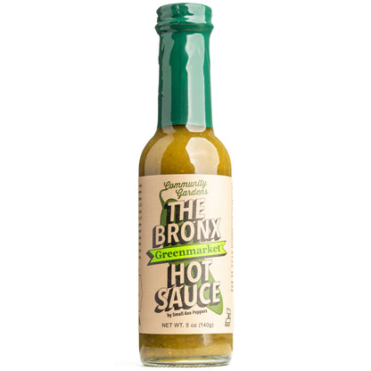 Bottle of The Bronx Hot Sauce with green cap on a white background