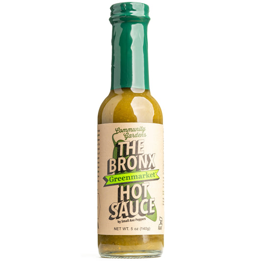 Bottle of The Bronx Hot Sauce with green cap on a white background