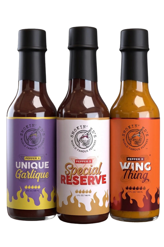 Three bottles of Smokin' Ed's Pepper X Hot Sauces