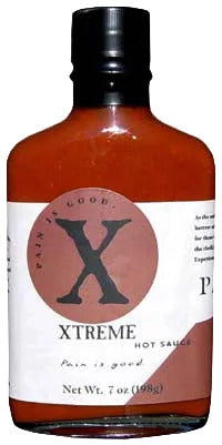 Bottle of Xtreme hot sauce with a red label and black cap.