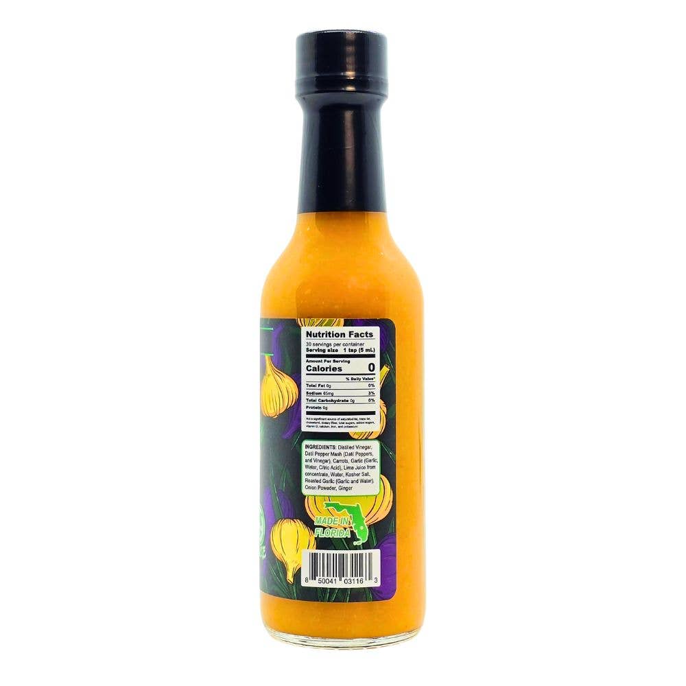 A bottle of hot sauce with bright orange liquid, a black cap, and a dark label featuring garlic illustrations, shown against a plain white background.