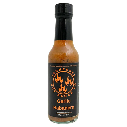 Bottle of Garlic Habanero sauce with a black label on a white background