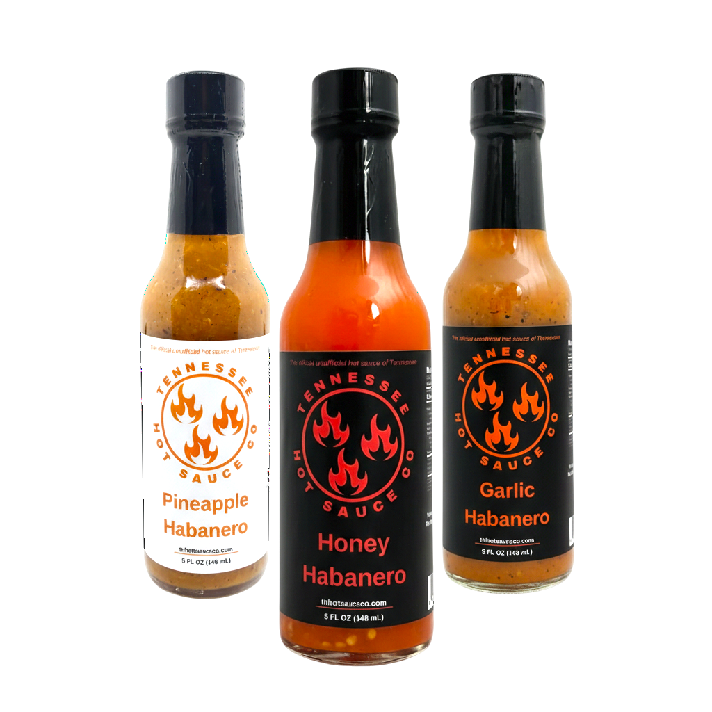 Three bottles of Tennessee Hot Sauce Co. hot sauce on a white background