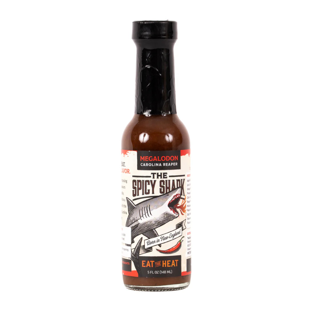 Bottle of 'The Spicy Shark' hot sauce with a label on a white background