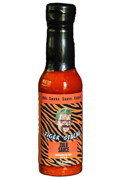 Bottle of Tiger Stache Zulu hot sauce on a dark background