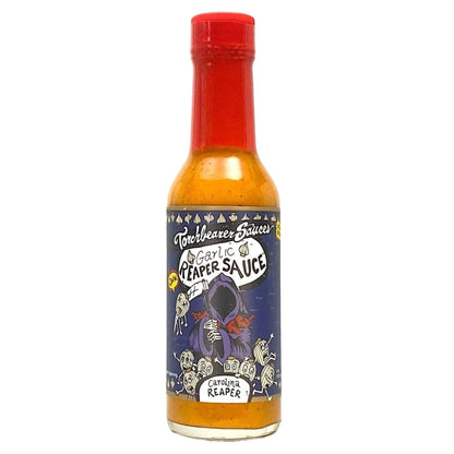 Bottle of Torchbearer Garlic Reaper Sauce with a colorful label on a white background