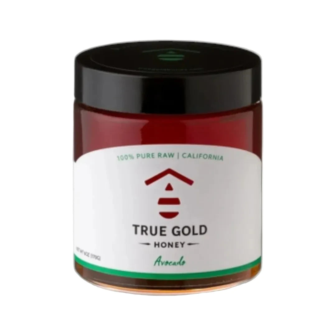 Jar of True Gold Honey with a black lid on a white background