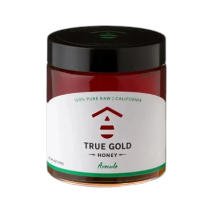 Jar of True Gold Honey with a black lid on a white background