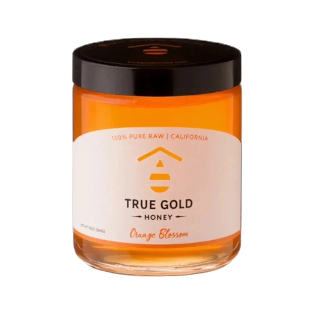 Jar of True Gold Honey with a black lid on a white background