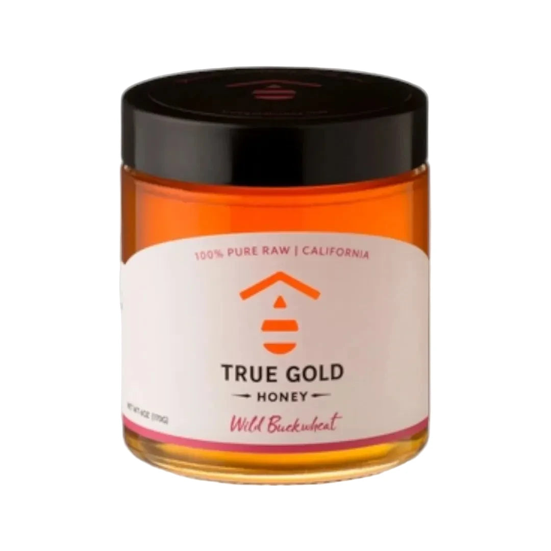 Jar of True Gold Honey with a black lid on a white background