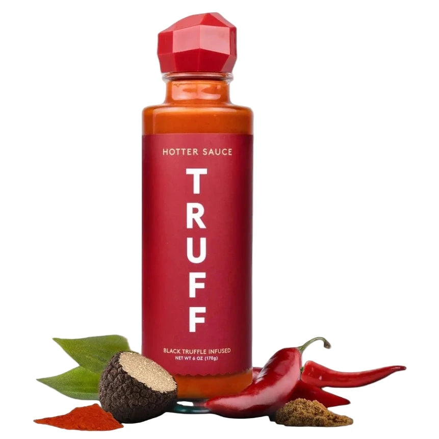 Red hot sauce bottle labeled 'TRUFF' with truffle and chili peppers on a white background