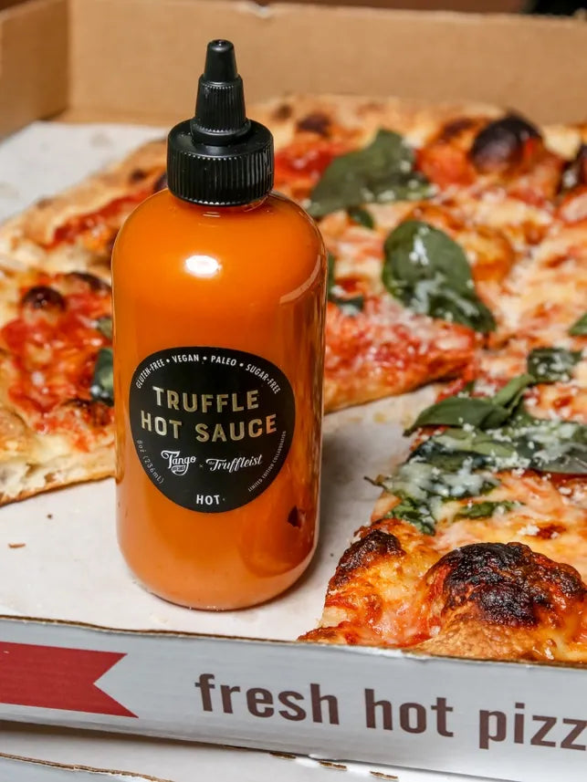 Bottle of Truffleist hot sauce with pizza