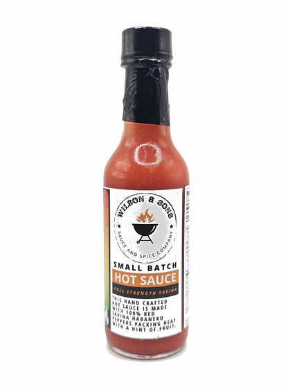 Bottle of Wilson and Sons Savina hot sauce with a black cap on a white background