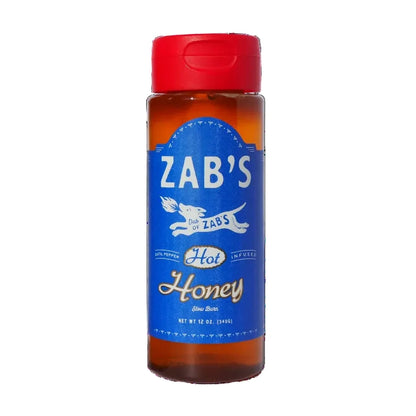 Bottle of Zab's Hot Honey with a red cap on a white background
