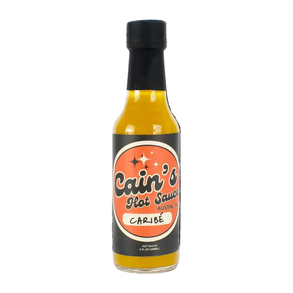 Bottle of Cain's Hot Sauce Caribe on a white background