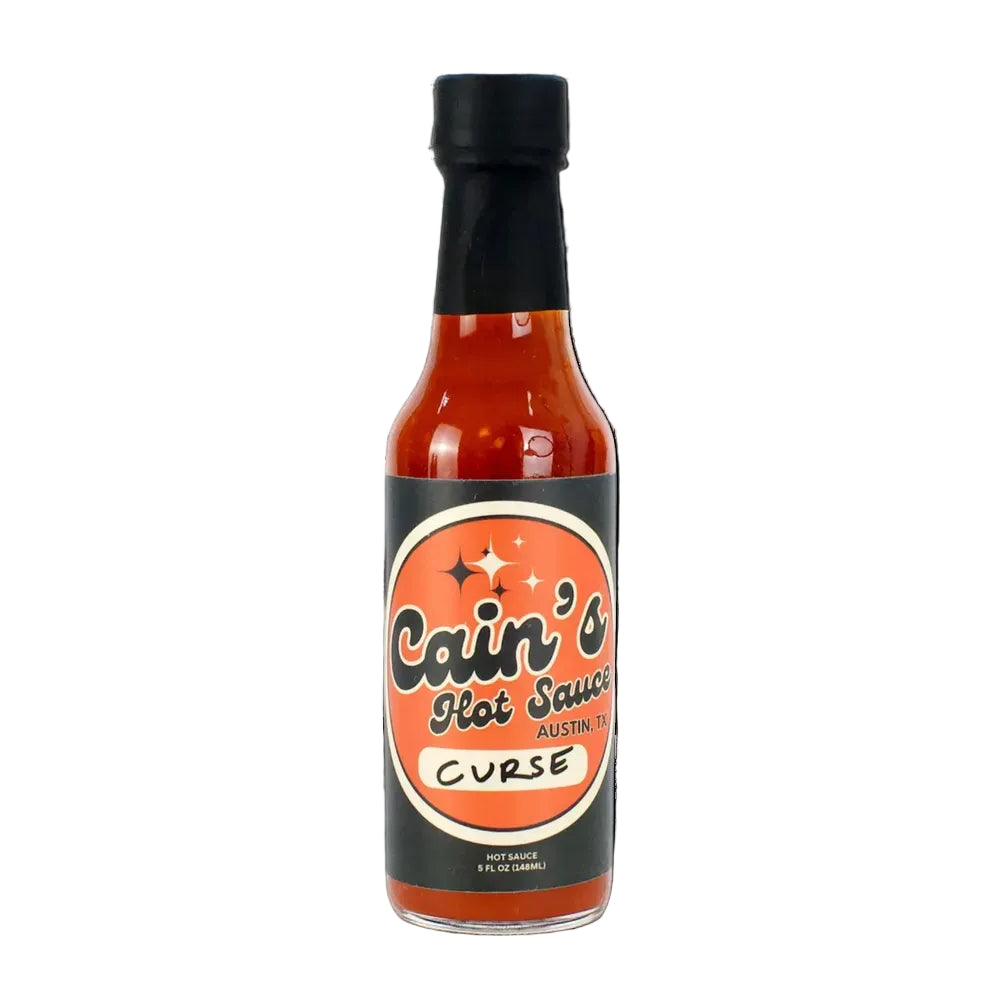 Bottle of Cain's Hot Sauce with a black cap on a white background