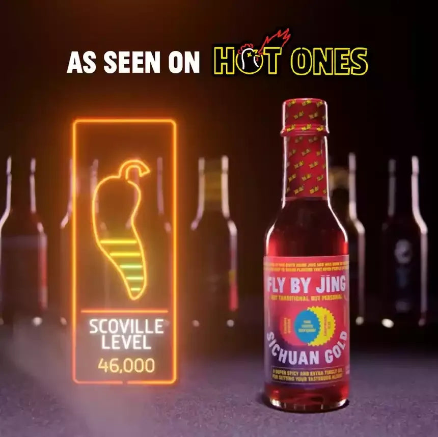 Bottle of Fly by Jing Sichuan Gold hot sauce with a Scoville level display, set against a dark background with 'Hot Ones' branding.