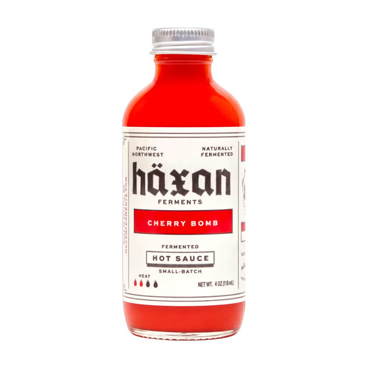 Bottle of Häxan Ferments Cherry Bomb fermented hot sauce on a white background