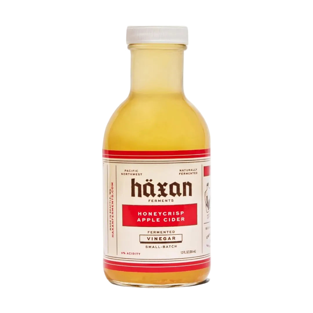 Bottle of Häxan Honeycrisp Apple Cider Vinegar on a white background