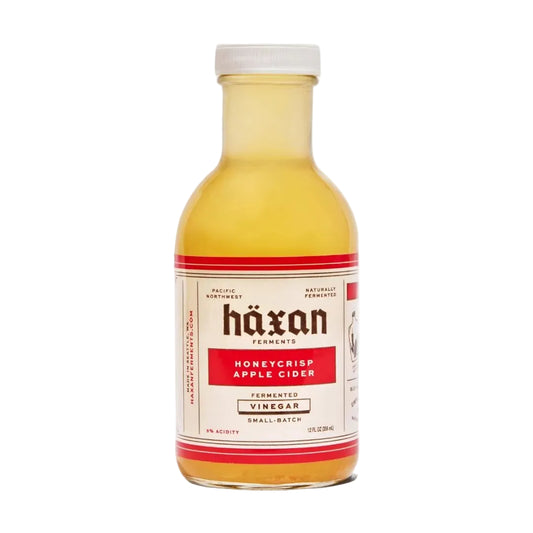 Bottle of Häxan Honeycrisp Apple Cider Vinegar on a white background