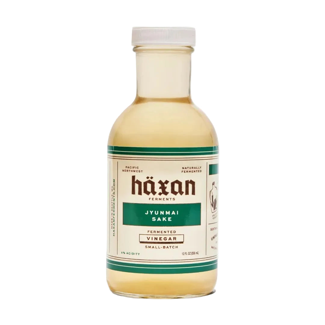 Bottle of Häxan Jyunmai Sake vinegar on a white background
