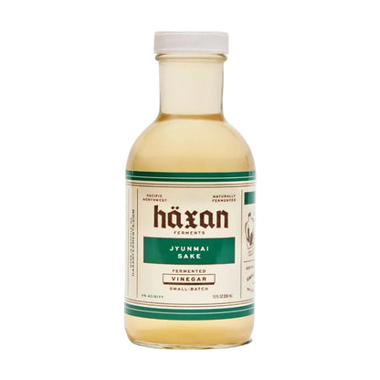 Bottle of Häxan Jyunmai Sake vinegar on a white background