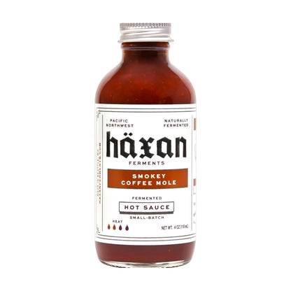 Bottle of Häxan Smokey Coffee Mole hot sauce on a white background