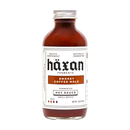 Bottle of Häxan Smokey Coffee Mole hot sauce on a white background