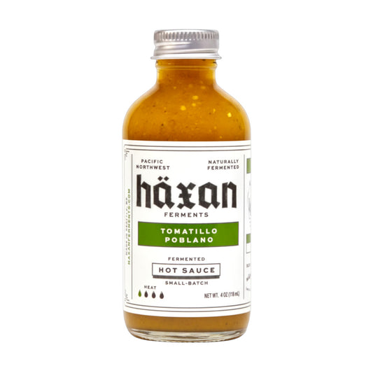Bottle of Häxan Tomatillo Poblano hot sauce on a white background