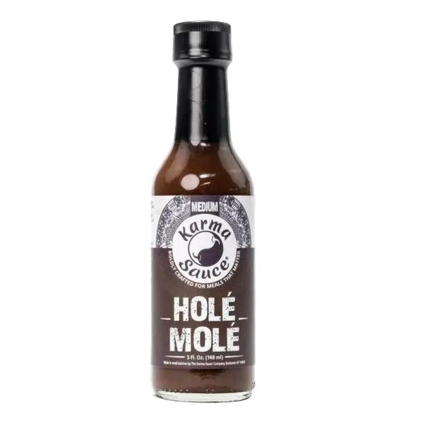 Bottle of Karma Sauce Hole Mole on a white background