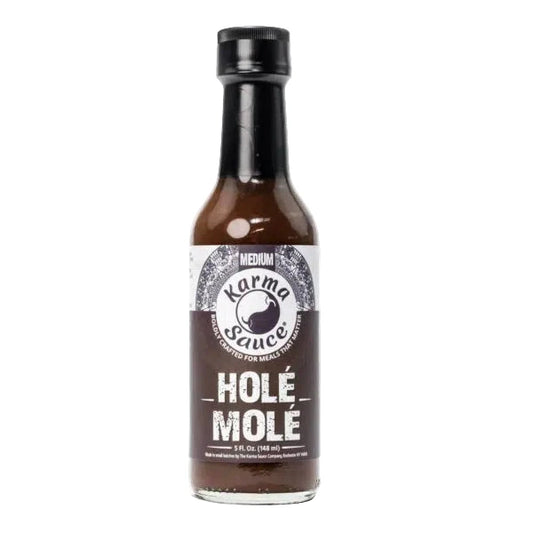 Bottle of Karma Sauce Hole Mole on a white background