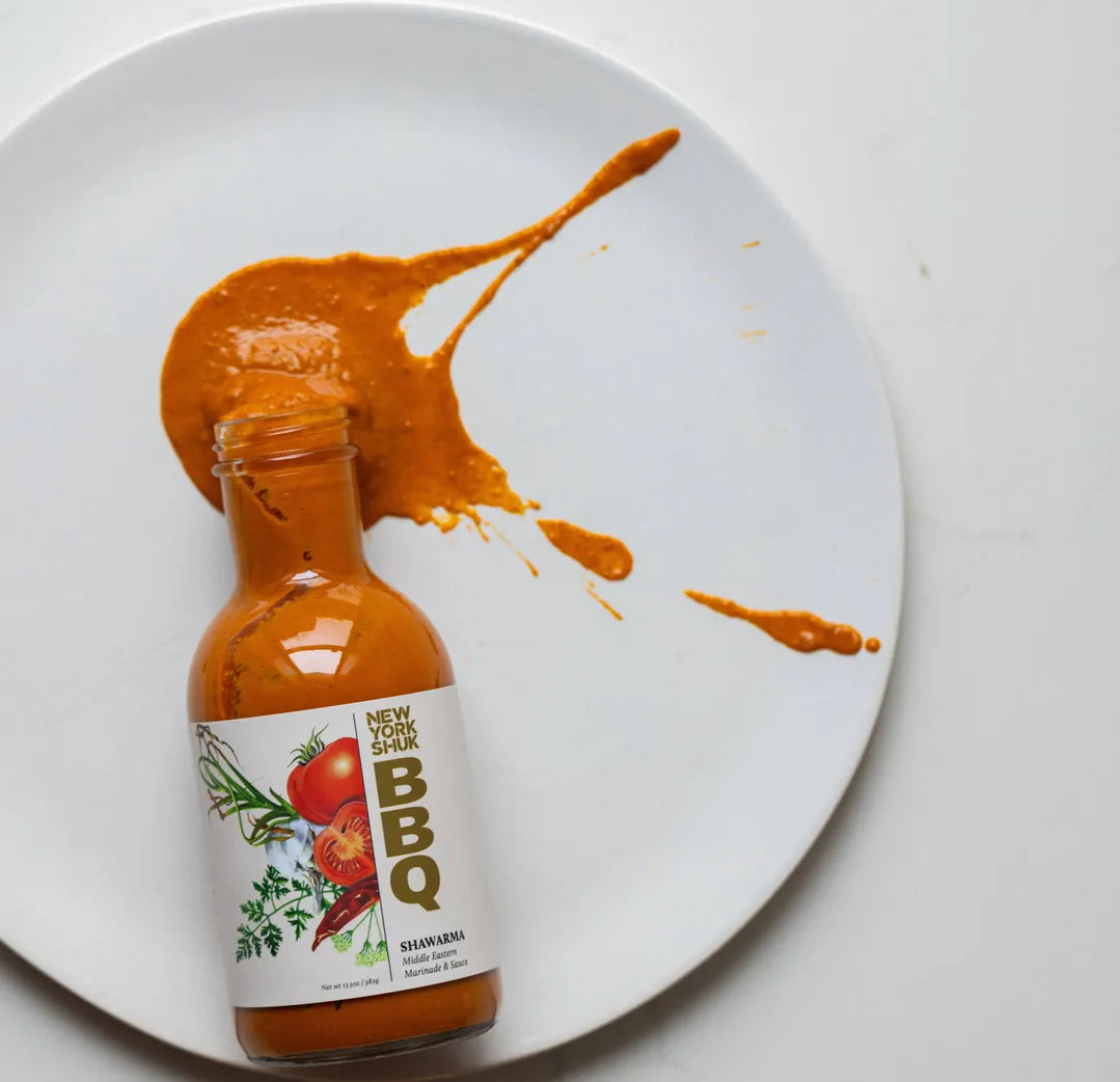 Bottle of New York Style BBQ sauce with a splash on a white plate