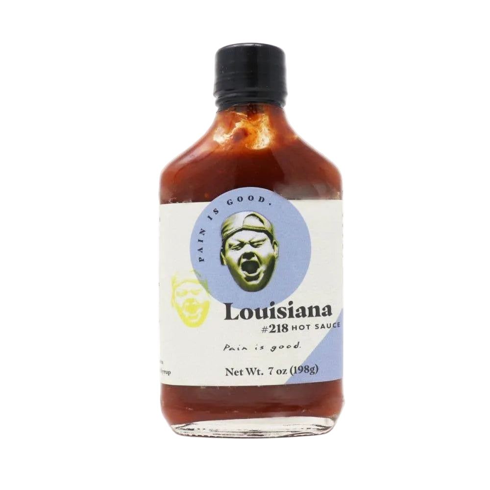 Bottle of Louisiana hot sauce with a label featuring a face and text on a white background