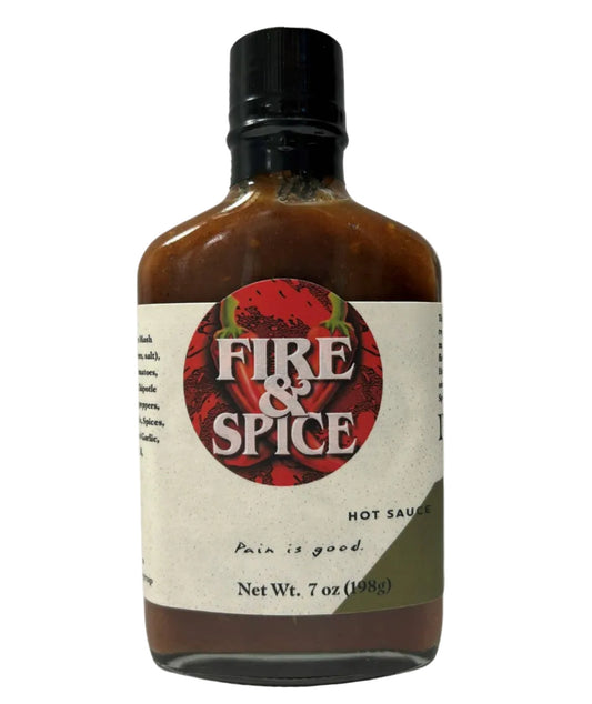 Bottle of Fire & Spice hot sauce on a white background