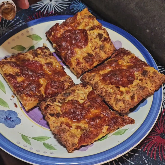 Rocky's hot sauce being poured over pizza
