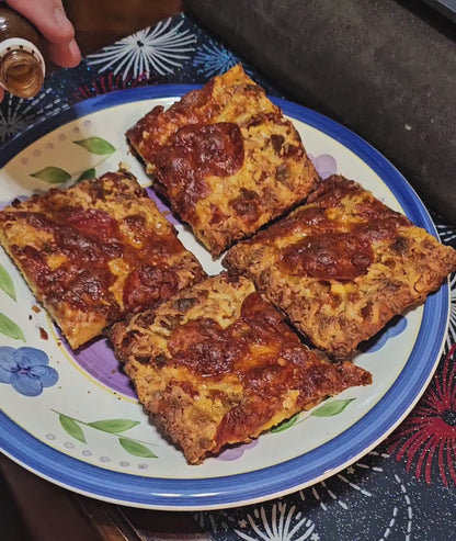 Rocky's hot sauce being poured over pizza
